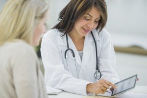 Doctor talking to patient with mobile device