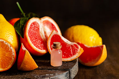 Cut up oranges surrounding a vial of liquid