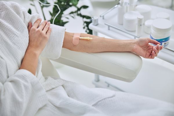 Cropped photo of female patient receiving IV Ozone Therapy